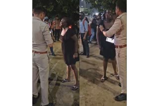 African girl in a state of drunken commotion, tangled with passers-by and police officers