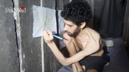 This image from an undated video released on August 1, 2025, by the armed wing of the Palestinian militant group Hamas, shows Israeli hostage Evyatar David marking a food log on a calendar inside the Gaza tunnel where he is being held. David was abducted during the Hamas attack on October 7, 2023. Top left reads in Arabic " The military media - Hamas."