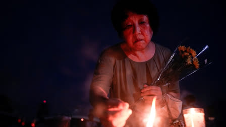 A visitor lights incense sticks at the Peace Memorial Park ahead of the memorial service to mark the 80th anniversary of the WWII U.S. atomic bombing in Hiroshima, Wednesday, Aug. 6, 2025, in Japan.