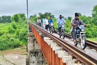 People Traveling on Railway Bridge In Mancherial District