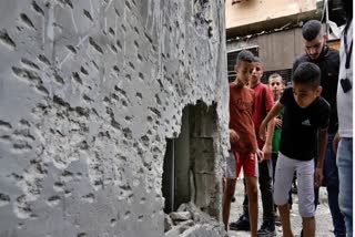 Children look at the damage following an Israeli airstrike in the Balata refugee camp, near the West Bank city of Nablus on July 27, 2024