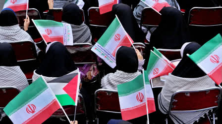 Demonstrators wave Iranian and Palestinian flags in an annual rally in front of the former U.S. Embassy in Tehran, Iran, Sunday, Nov. 3, 2024.