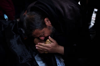 Palestinians mourn their relatives, killed in the Israeli bombardment of the Gaza Strip, outside a morgue in Rafah, southern Gaza, Tuesday, Feb. 6, 2024. (AP Photo/Fatima Shbair)