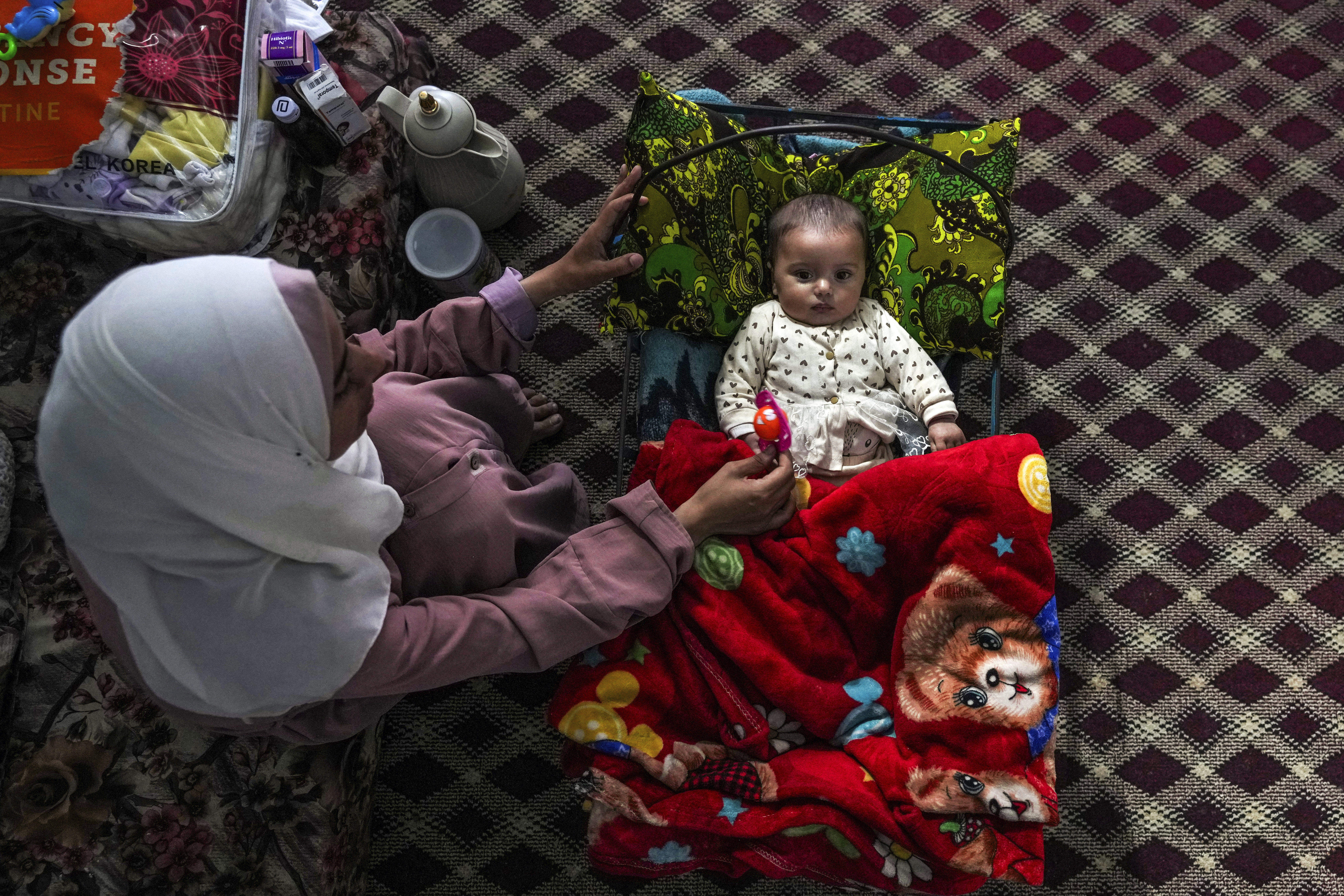 - Rola Saqer sits beside her baby Masa Mohammad Zaqout at her parents' home in the neighborhood of Zawaida, central Gaza, Thursday, April 4, 2024. Zaqout was born Oct. 7, the day the Israel-Hamas war erupted. Mothers who gave birth in the Gaza Strip that day fret that their 6-month-old babies have known nothing but brutal war, characterized by a lack of baby food, unsanitary shelter conditions and the crashing of airstrikes. (AP Photo/Abdel Kareem Hana)