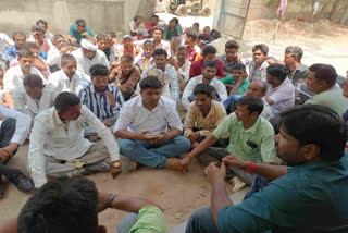Congress MLA Ganesh Ghoghra sitting on dharana with supporters in front of the mining department