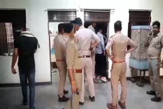 Police standing outside a house after a man accidentally shot dead his aunt in Uttar Pradesh's Jhansi