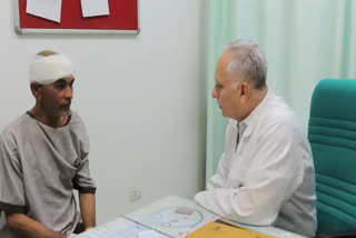 Patient with doctor after operation