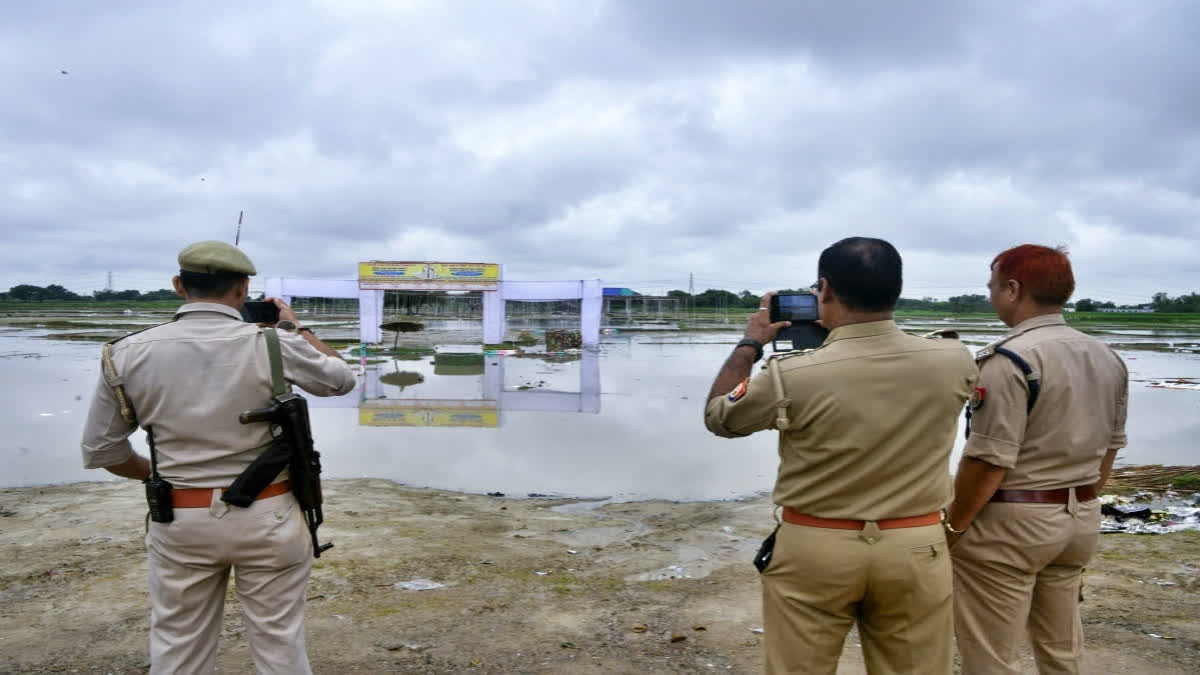 A team of police personnel investigate the 'Satsang' event site where the stampede incident occurred on July 2.