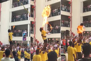 A young man is seen doing stunts with fire while breaking the pot