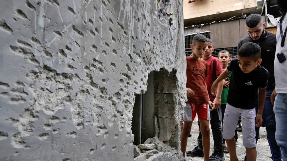 Children look at the damage following an Israeli airstrike in the Balata refugee camp, near the West Bank city of Nablus, Saturday, July 27, 2024.