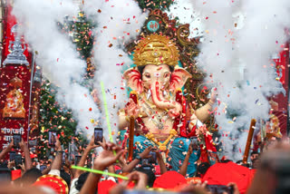 Devotees carry the idol of Lord Ganesha to a pandal on the eve of Ganesh Chaturthi, in Nagpur on Friday.