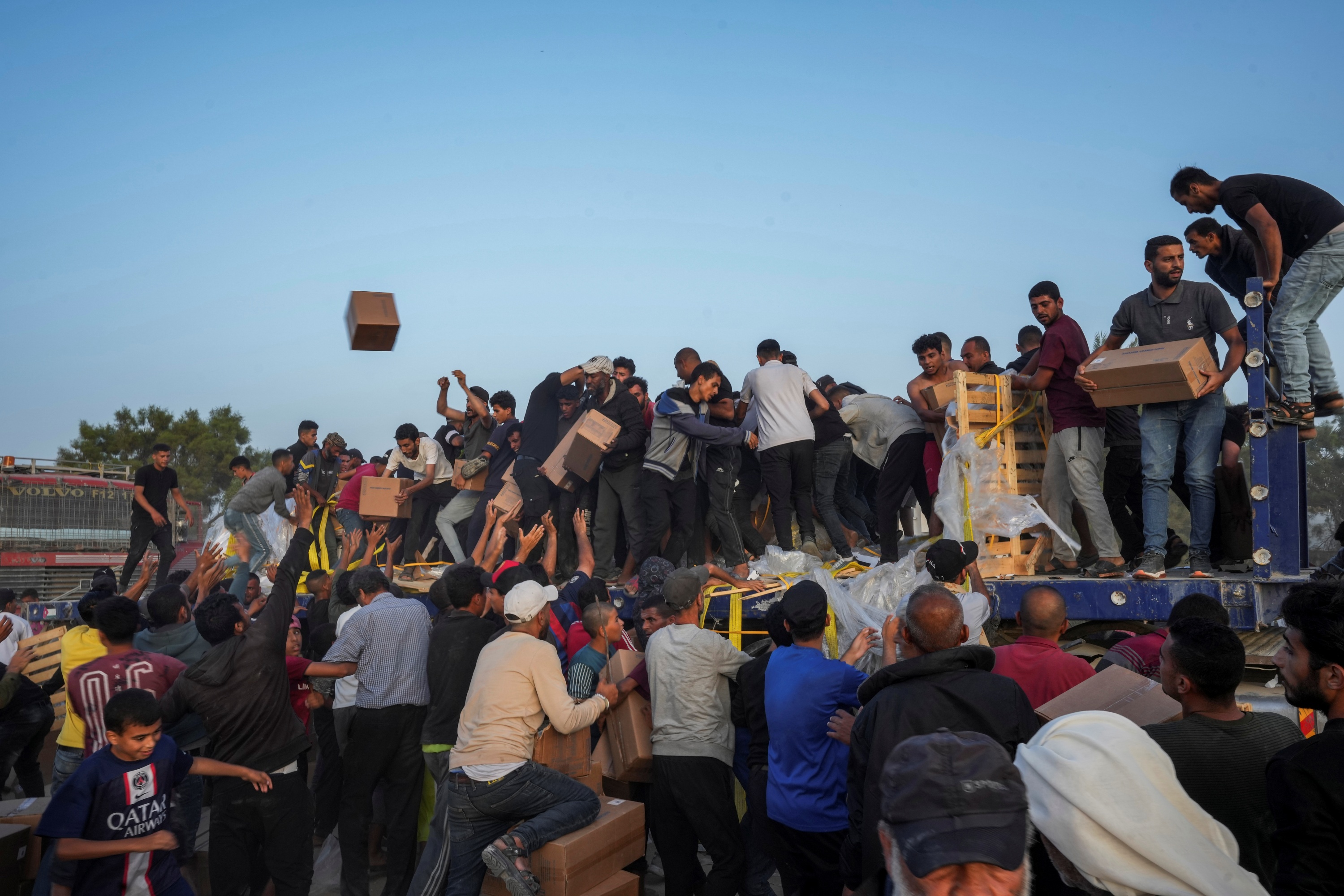 Palestinians are storming trucks loaded with humanitarian aid brought in through a new U.S.-built pier, in the central Gaza Strip, May 18, 2024.