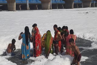 women took a dip in the foaming Yamuna
