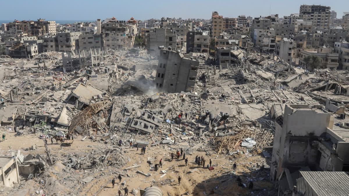 FILE - Palestinians search for bodies and survivors in the rubble of a residential building destroyed in an Israeli airstrike, in Rafah southern Gaza Strip, Wednesday, Dec. 20, 2023.