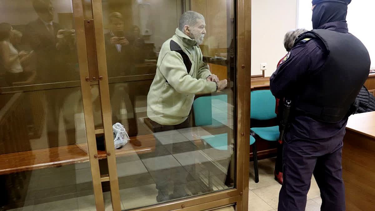 In this photo released by the Moscow City Court Press Service, Stephen Hubbard, a U.S. citizen accused of fighting as a mercenary in Ukraine against Russia stands in a glass cage during a court session in the Moscow City court in Moscow, Russia, Monday, Oct. 7, 2024.