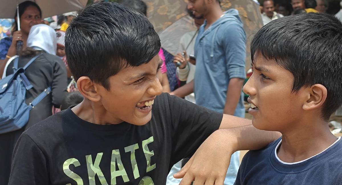 Two kids share a light moment at the event