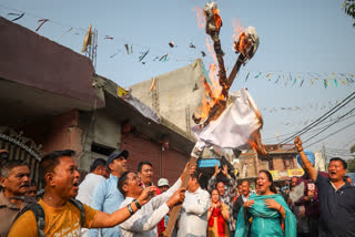 Members from the Gorkha community burn an effigy during a demonstration against the restoration of Articles 370 and 35A, in Jammu, Thursday, Nov. 7, 2024.