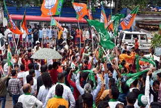 Supporters of various parties raise party flags during Jharkhand assembly election campaigning