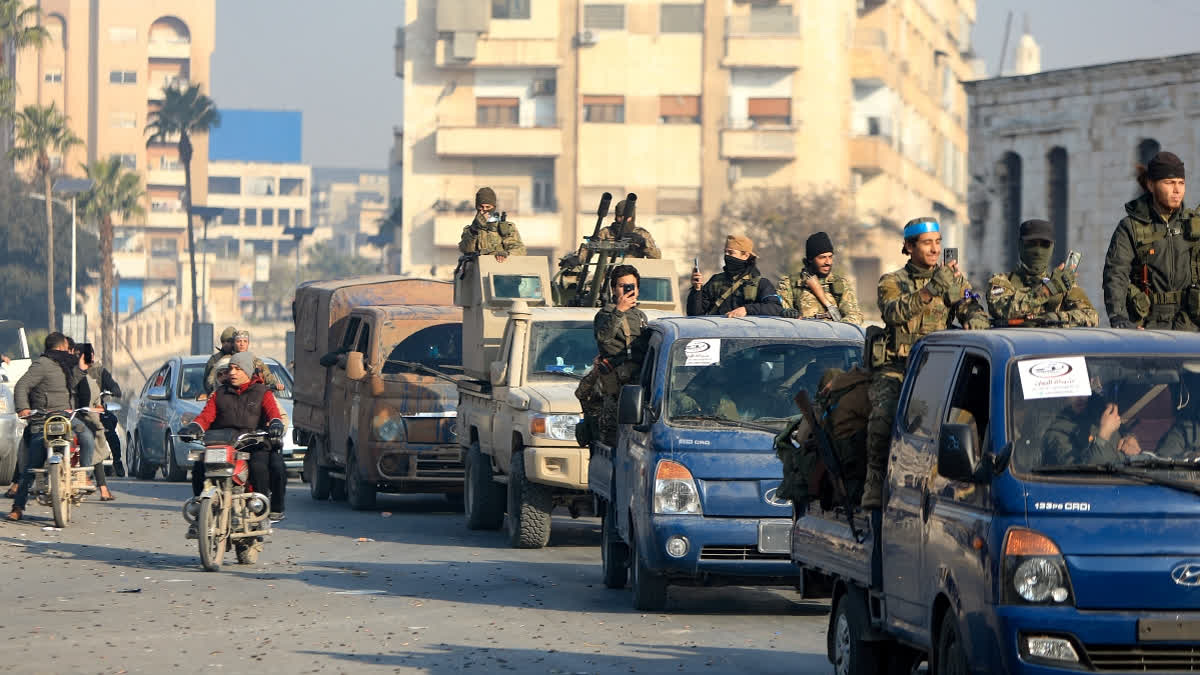 Anti-government fighters parade in the streets of Hama after forces captured the central city, on December 6, 2024. Rebel forces pressing a lightning offensive in Syria aim to overthrow President Bashar al-Assad's rule, their Islamist leader said in an interview published on December 6.