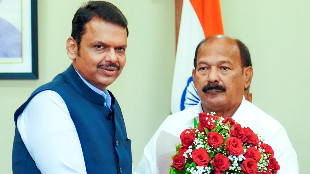 Maharashtra Chief Minister Devendra Fadnavis congratulates MLA Kalidas Kolambkar after he was elected as the pro-tem Speaker of the state Legislative Assembly, in Mumbai.