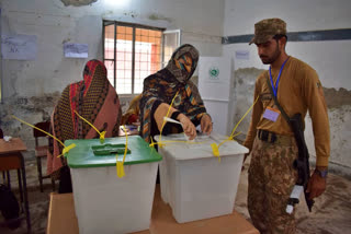 Voters arrive at polling stations on Thursday morning to vote a day after election-related violence killed at least 30 people in Pakistan. Tens of thousands of police and paramilitary forces have been deployed at polling stations to ensure security as Pakistan is electing a new parliament on Thursday.