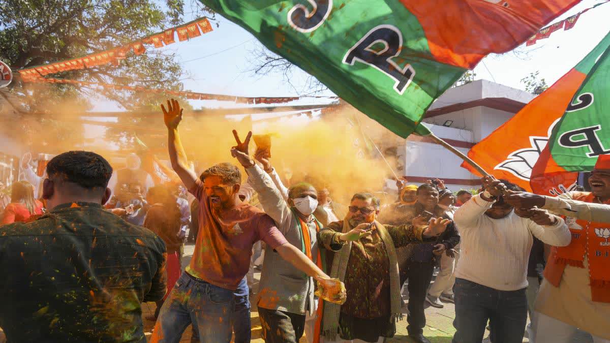 BJP supporters celebrate the party's decisive lead in the Delhi Assembly polls on Saturday.