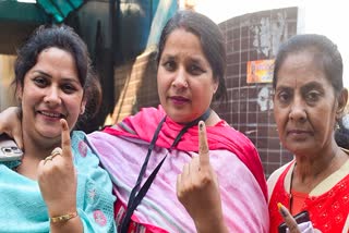 BJP Candidate from Najafgarh Assembly Constituency, Neelam Krishan Pahalwan shows her ink-marked finger after casting her vote for the Delhi Assembly elections, in New Delhi