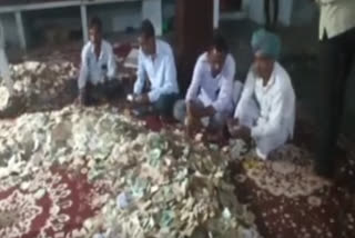 Temple Trust members and employees counting the amount from the donation box of Shani Dev Temple.