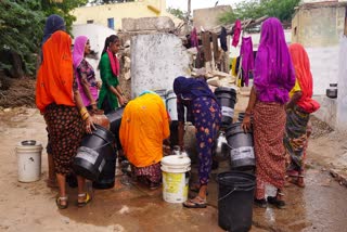 Villagers collect drinking water from a roadside tap on a hot summer day, in Ajmer, Rajasthan..