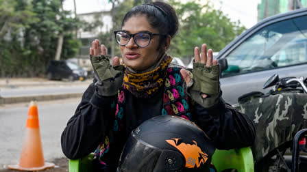 In this photograph taken on August 19, 2024, Amina Sohail, a motorbike rider with a local ride-hailing service provider Bykea, speaks during an interview with AFP in Karachi.