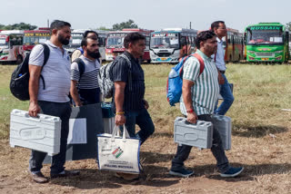 Polling officials carry the election materials as they leave for their respective polling booths on the eve of the third and final phase of Jammu and Kashmir Assembly elections