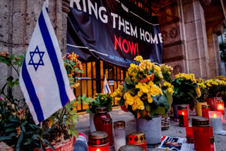 Candles and flowers are laid at the entrance of the synagogue to mark the first anniversary of the Hamas attack on Israel, Frankfurt, Germany, Monday, Oct. 7, 2024.