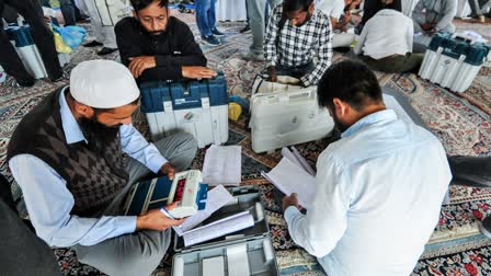 Polling officials check their EVMs and other election materials before leaving for their respective polling stations on the eve of the final phase of the Jammu and Kashmir Assembly elections