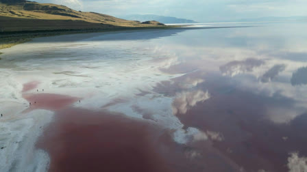 People visit the pink water section near Stansbury Island at the Great Salt Lake in Salt Lake City, Utah on September 9, 2024.