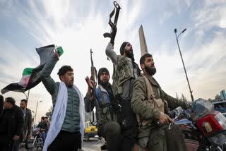 Syrian opposition fighters celebrate after the Syrian government collapsed in Damascus, Syria, Sunday, Dec. 8, 2024. Syrian President Bashar Al Assad flees the war-torn country