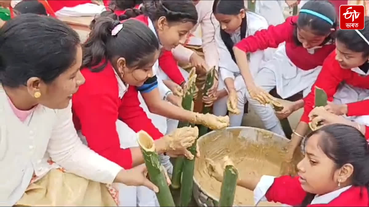 Students make chunga pitha before Bhogali Bihu in a school of Majuli