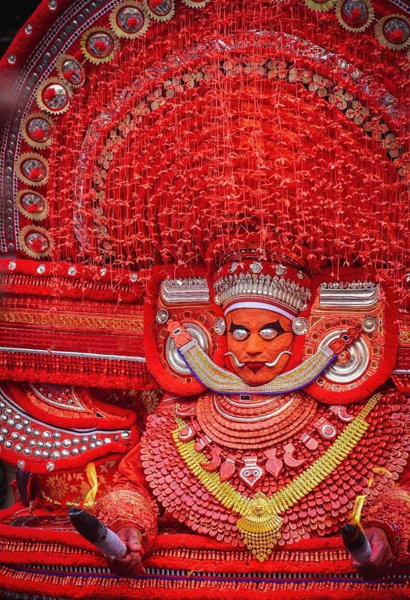 KERALA THEYYAM ART FORM  THEYYAM ART FORM HISTORY  BELIEFS BEHIND THEYYAM  MAKEUP DRESS OF THEYYAM