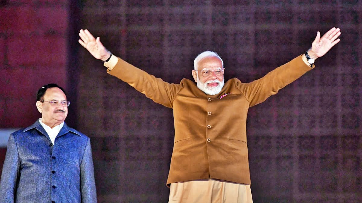 PM Narendra Modi greets supporters as he arrives at BJP headquarters on the party's win in the Delhi Assembly elections, in New Delhi on Saturday.