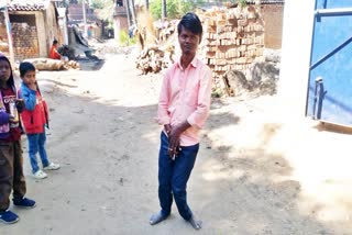 A boy with bent knees at Churaman Nagar village.