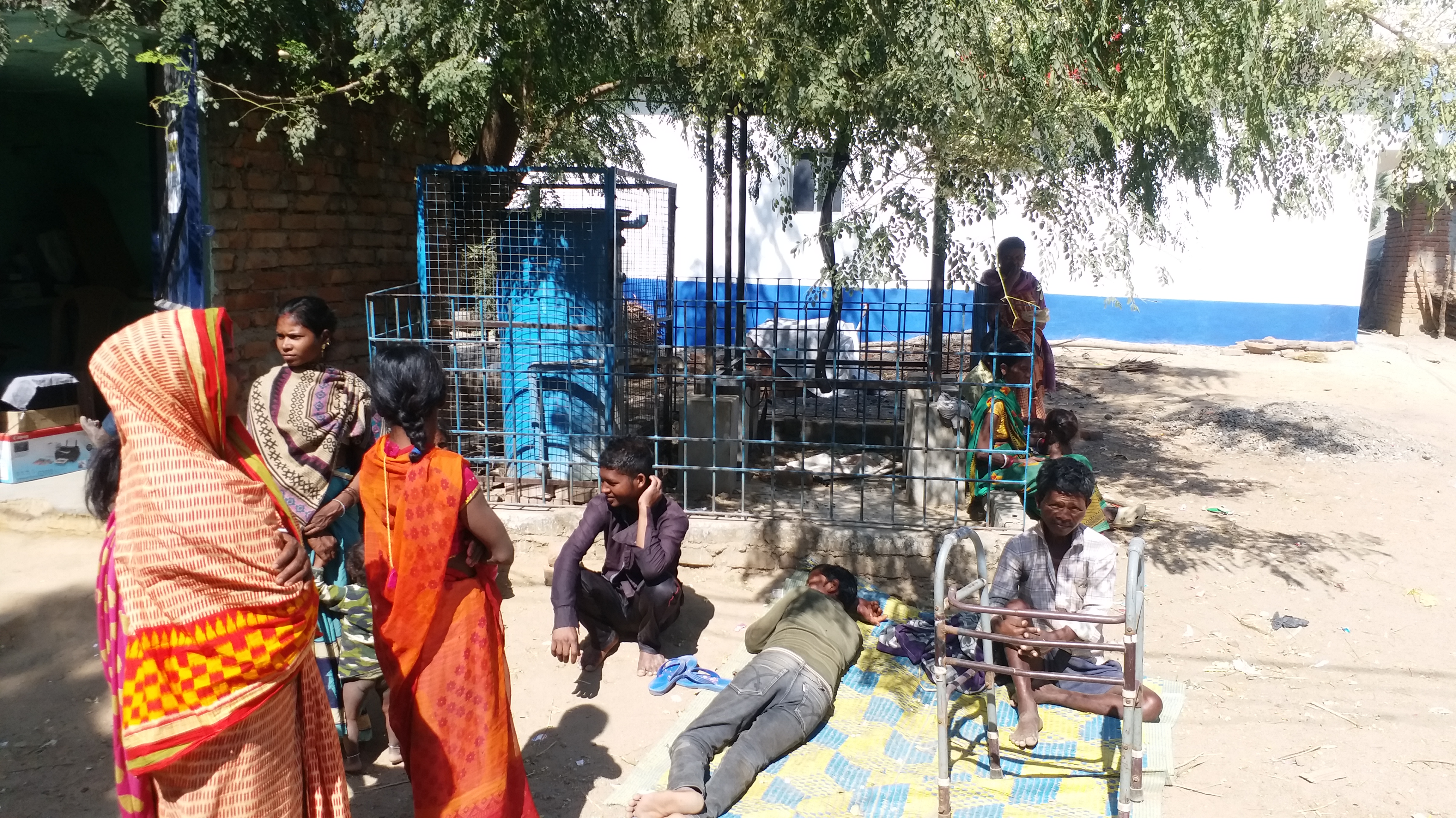 Villagers near the water purifier which has been dysfunctional for a while.