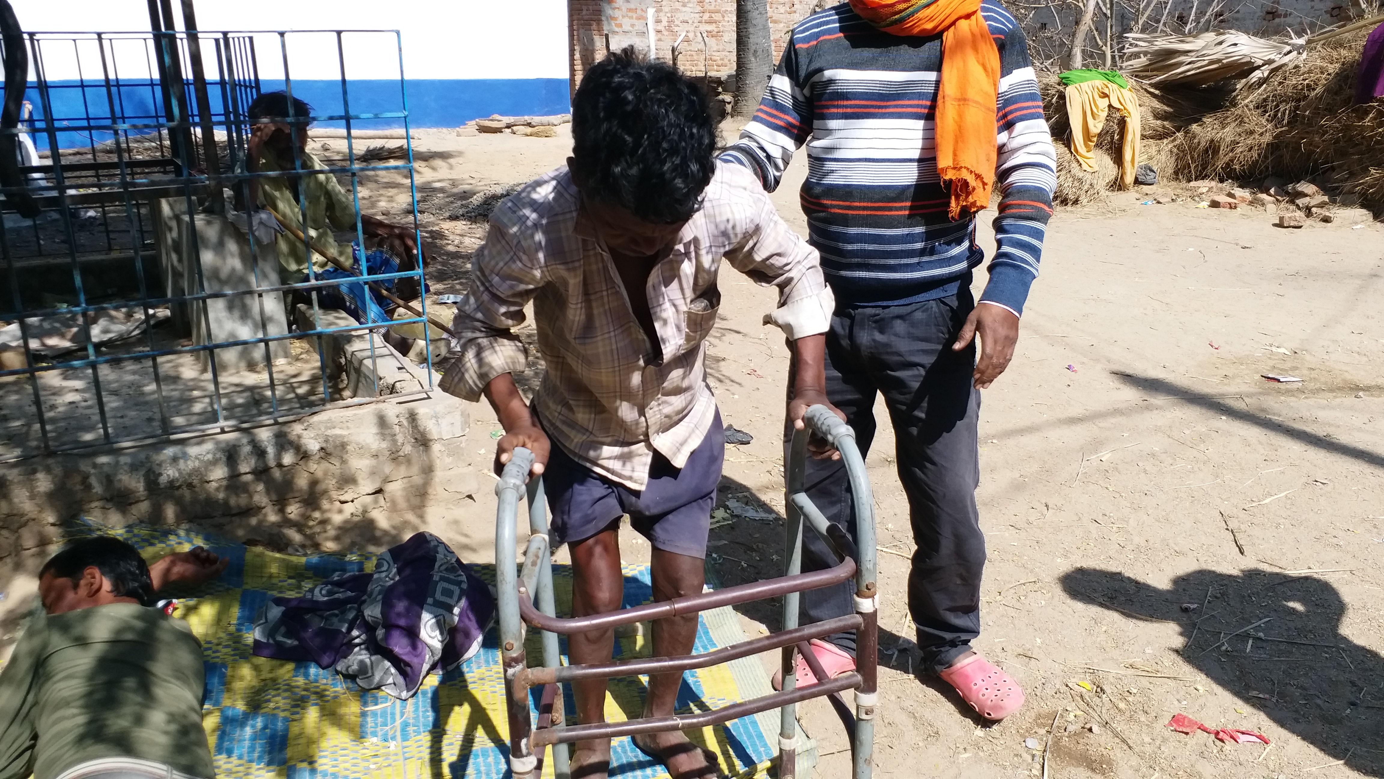 A boy with a walker in the village.