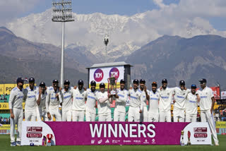 Indian cricket team members pose with the winning trophy after they won the fifth test match against England in Dharamshala, India, Saturday, March 9, 2024.