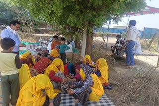 Women sitting on strike in Sikandra demanding removal of coal factory