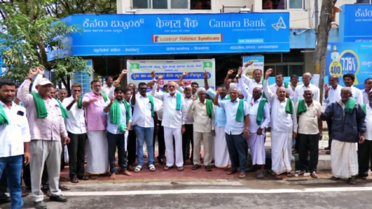 Farmers protest in front of the bank