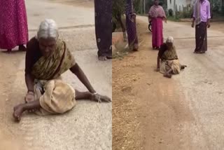 Woman Crawling On Road For Pension