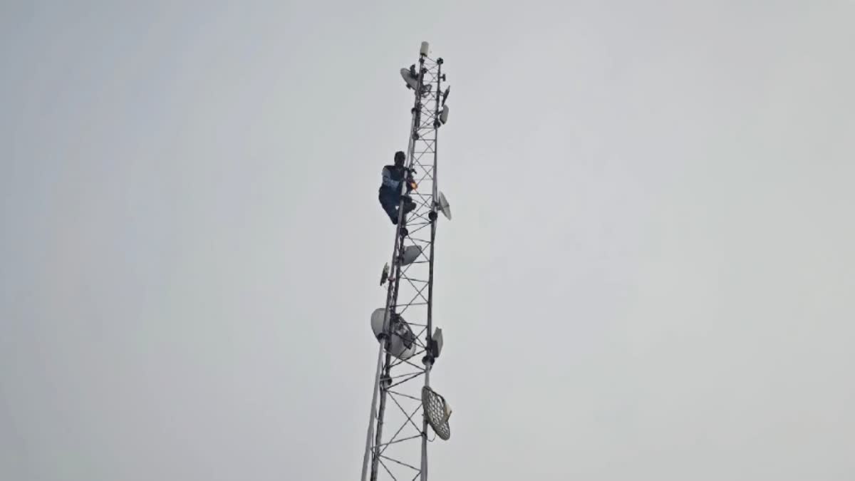 man climbed the tower with a bottle of petrol