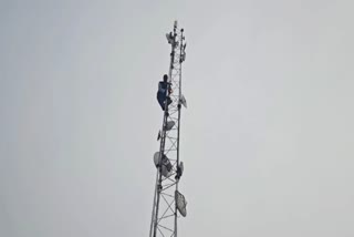 man climbed the tower with a bottle of petrol