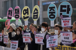 Protesters shout slogans during a press conference demanding to stop the upcoming Freedom Shield military exercise between the U.S. and South Korea, near the Defense Ministry in Seoul, South Korea, Monday, March 10, 2025. The letters read "Stop, War exercise."
