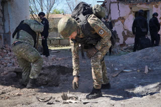 Russia pounded a town in Ukraine's northeast with artillery, rockets and guided aerial bombs Friday before attempting an infantry breach of local defences, authorities said, in a tactical switch that Kyiv officials have been expecting for weeks as the war stretches into its third year.
