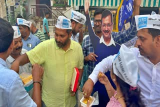 AAP workers celebrated by distributing sweets.